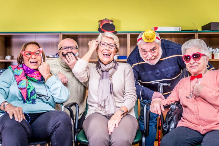 senior people inside an retirement facility laughing