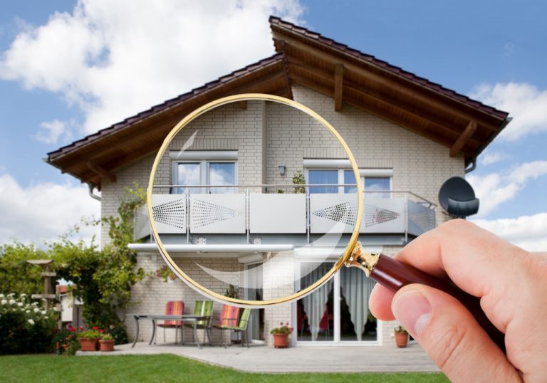a house behind magnifying glass