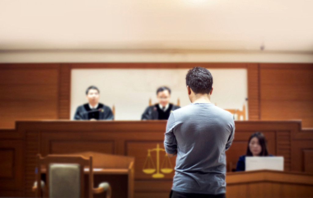 A court room with two judges and the accused