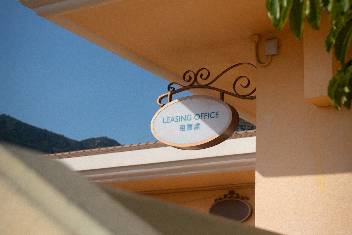 A Hanging Signage of a Leasing Office