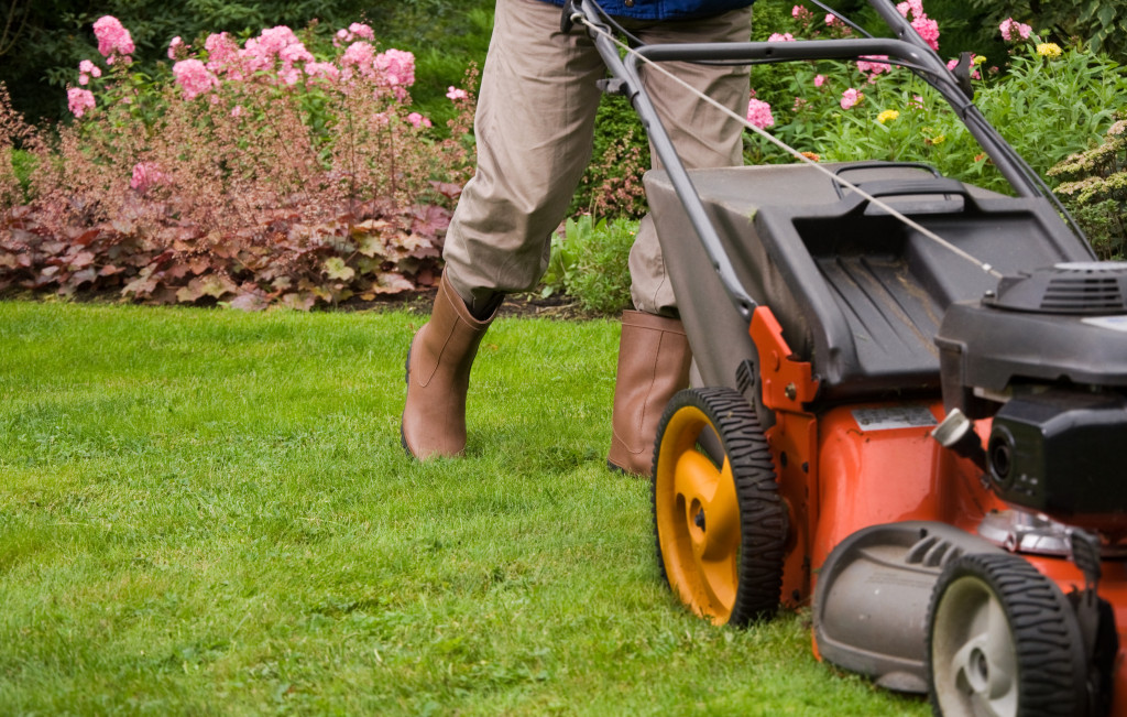 A gardener mowing the grass